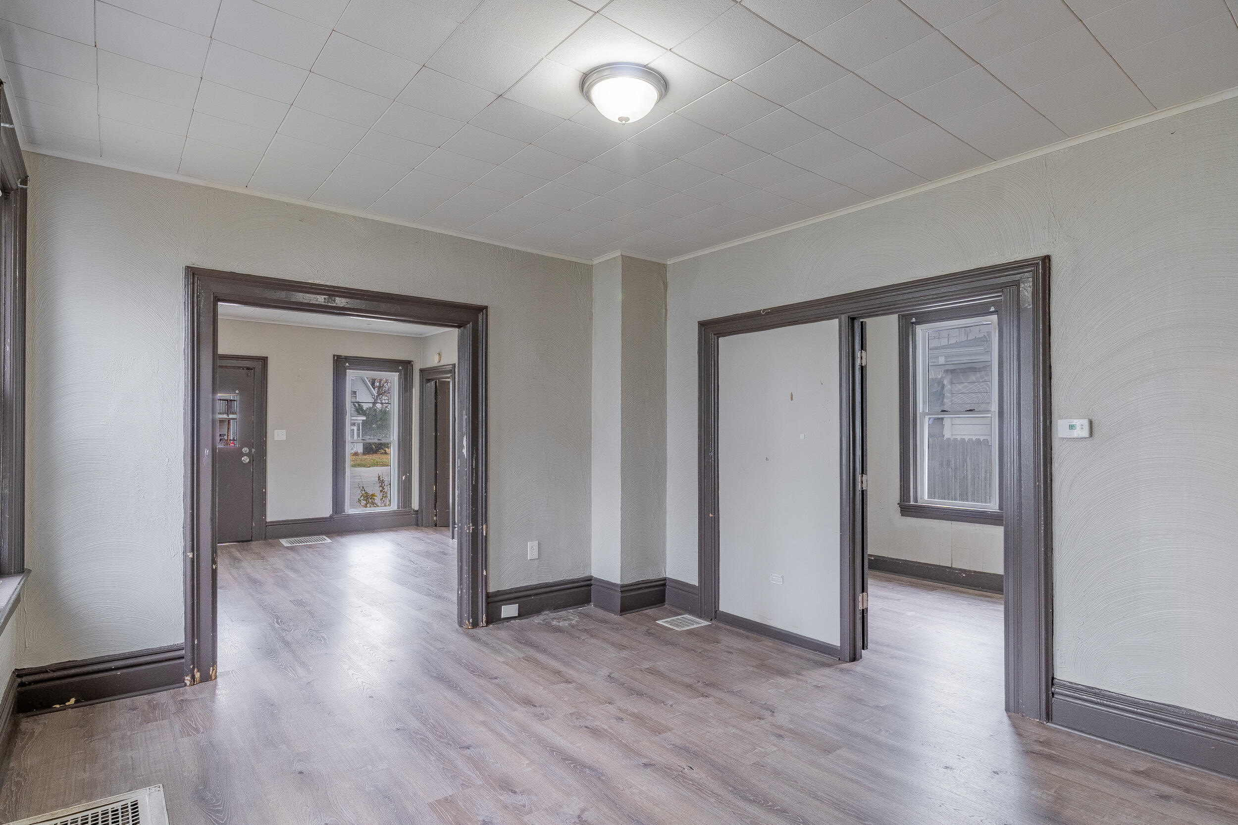 403 Rose Street La Porte, IN 46350 - Photo 8 of 28 an empty room with wooden floor and windows