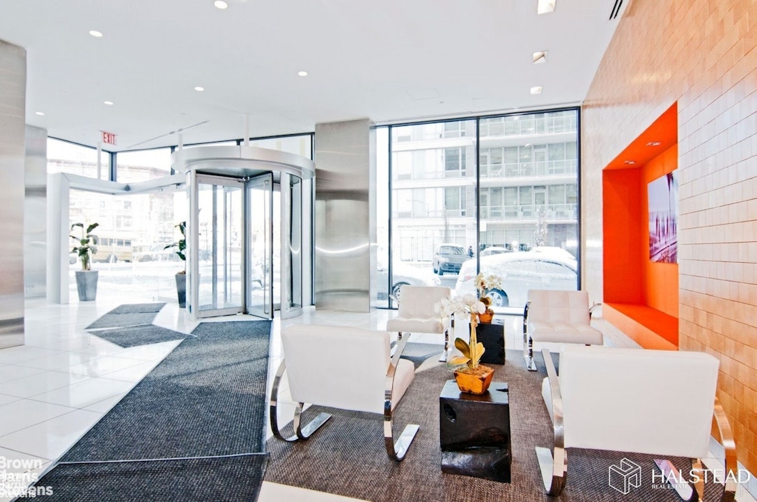 11-02 49th Avenue, Unit 8A Queens, NY 11101 - Photo 10 of 36 a living room filled with furniture and a large window