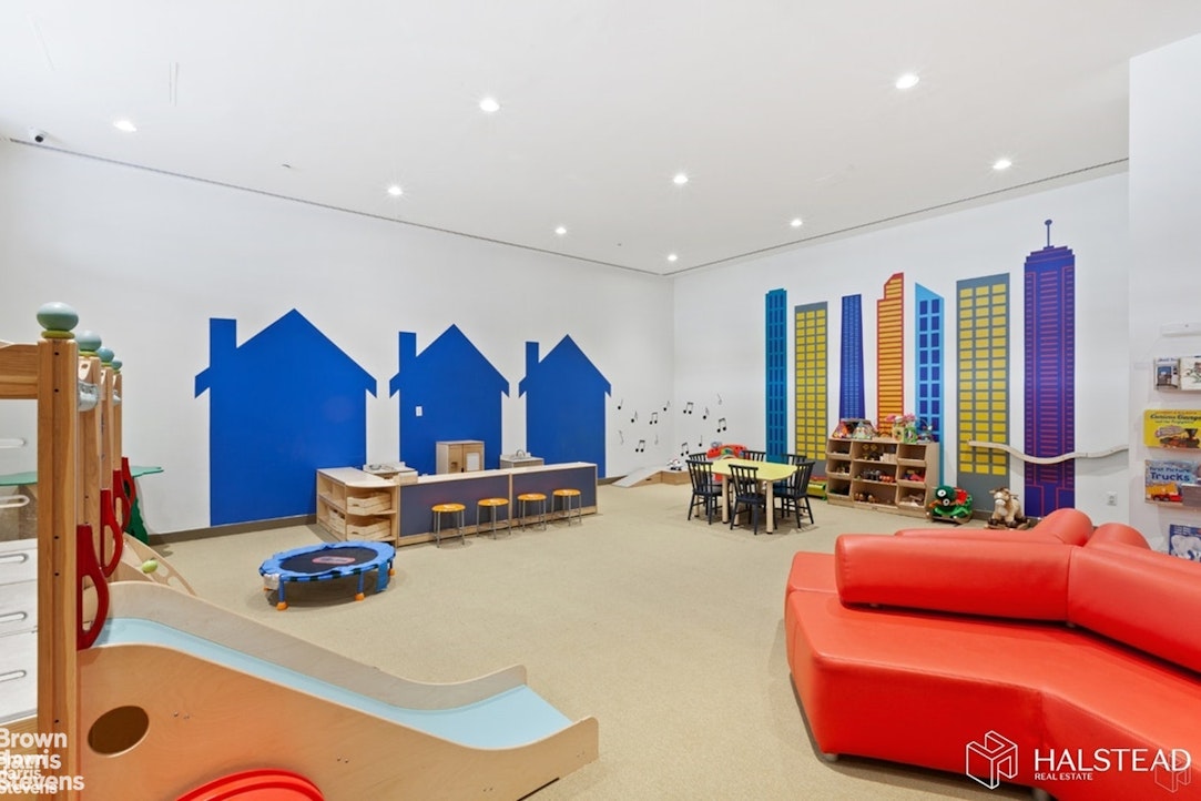 11-02 49th Avenue, Unit 8A Queens, NY 11101 - Photo 13 of 36 a living room with furniture gym equipment and a large window