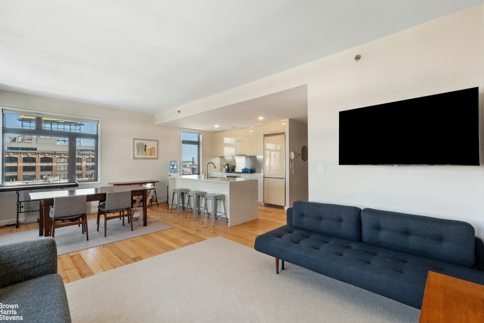 11-02 49th Avenue, Unit 8A Queens, NY 11101 - Photo 20 of 36 a living room with furniture and a flat screen tv