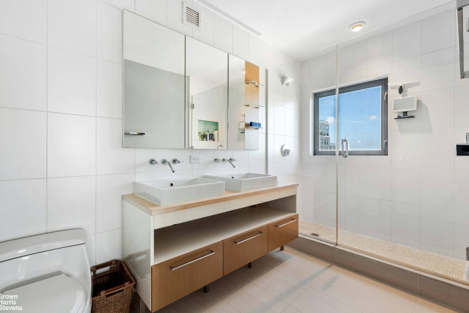 11-02 49th Avenue, Unit 8A Queens, NY 11101 - Photo 24 of 36 a bathroom with a sink and a mirror