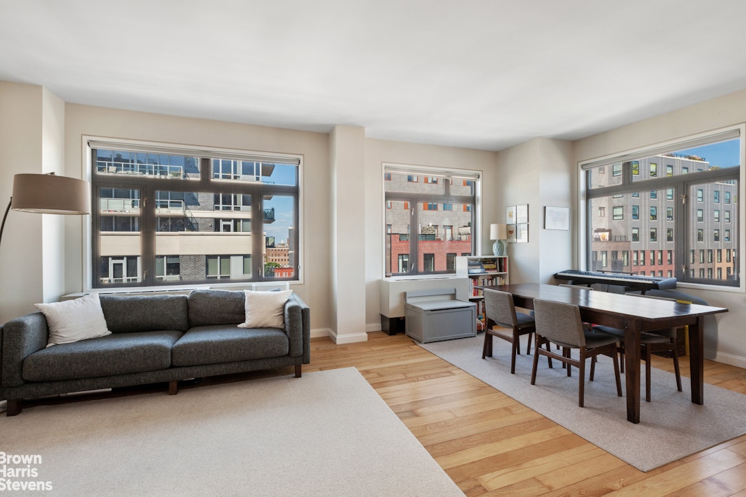 11-02 49th Avenue, Unit 8A Queens, NY 11101 - Photo 5 of 36 a living room with furniture a rug and a table