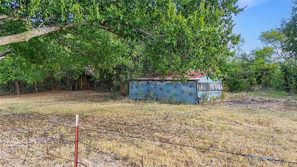 917 Goodwyn Road Italy, TX 76651 - Photo 37 of 40 Expansive open field with scattered mature trees and two outbuildings