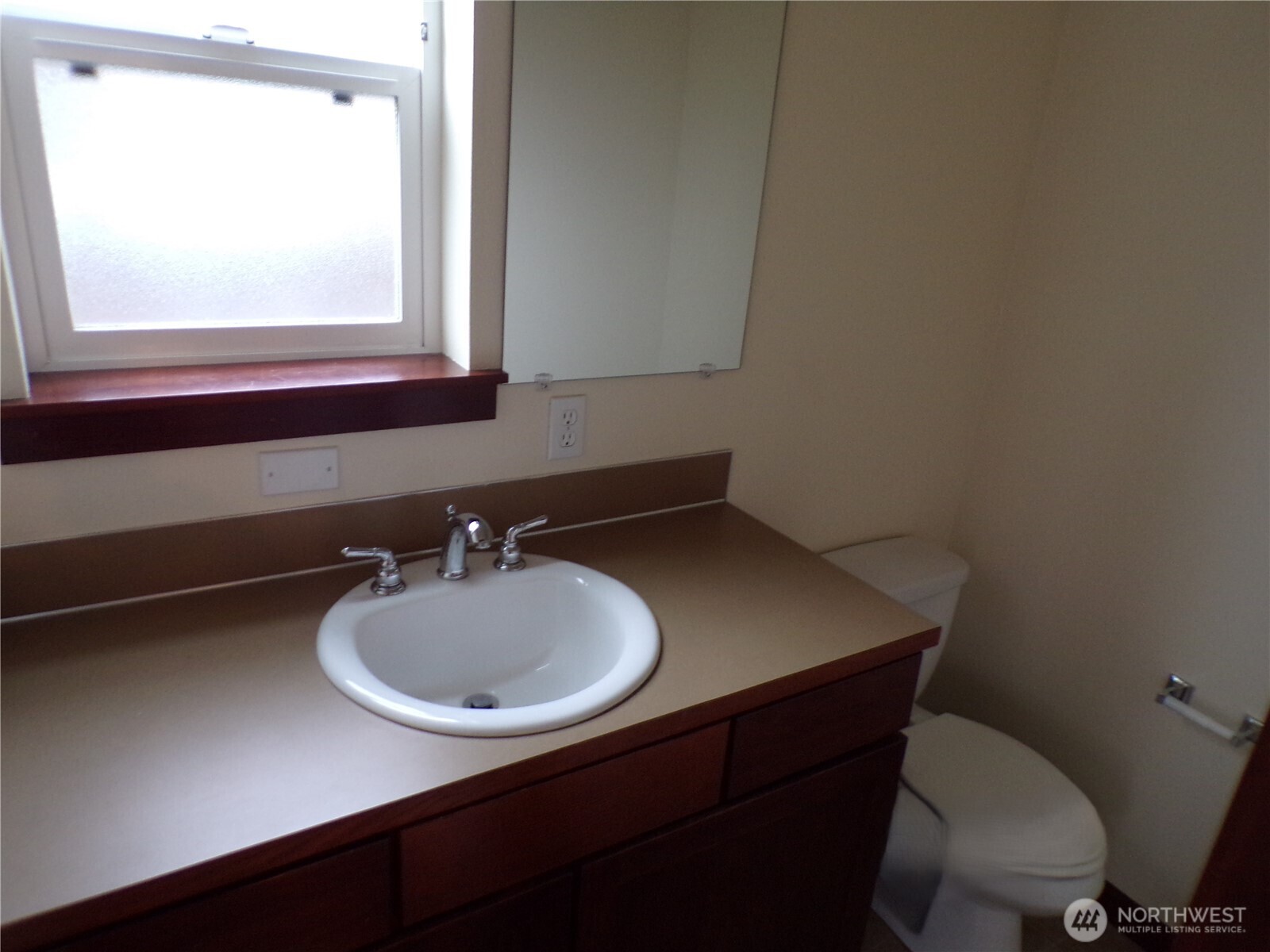 501 North 105th Street, Unit A Seattle, WA 98133 - Photo 11 of 39 a bathroom with a sink a mirror and a toilet