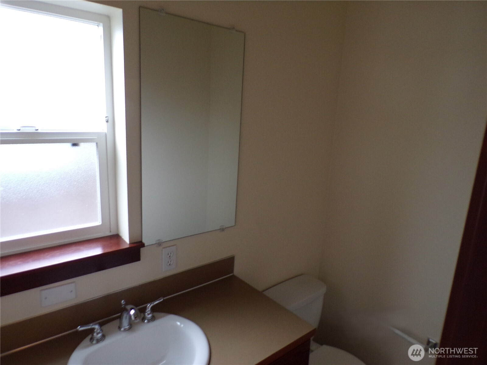 501 North 105th Street, Unit A Seattle, WA 98133 - Photo 12 of 39 a bathroom with a sink a mirror and a window