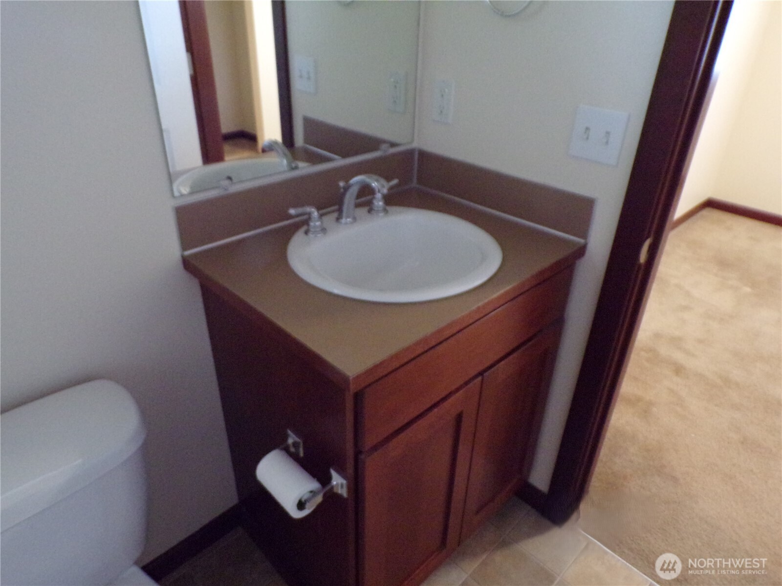 501 North 105th Street, Unit A Seattle, WA 98133 - Photo 23 of 39 a bathroom with a sink and a mirror