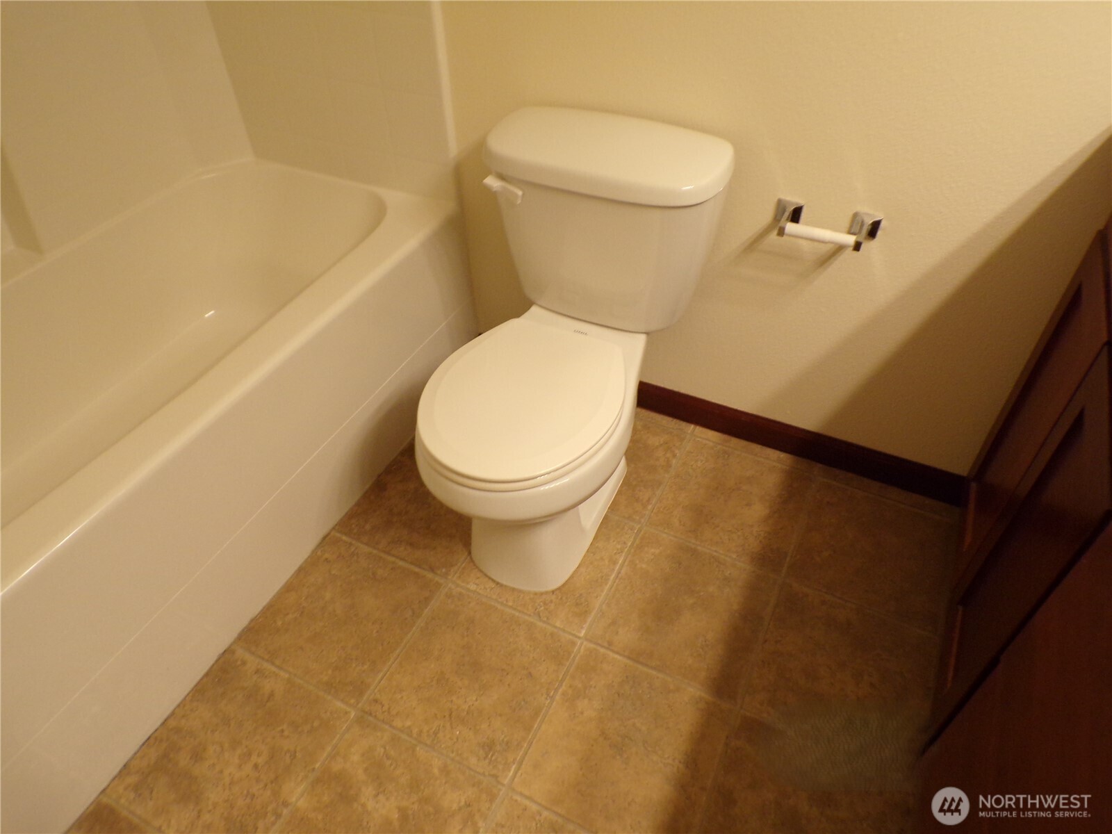 501 North 105th Street, Unit A Seattle, WA 98133 - Photo 30 of 39 a white toilet sitting next to a bath tub