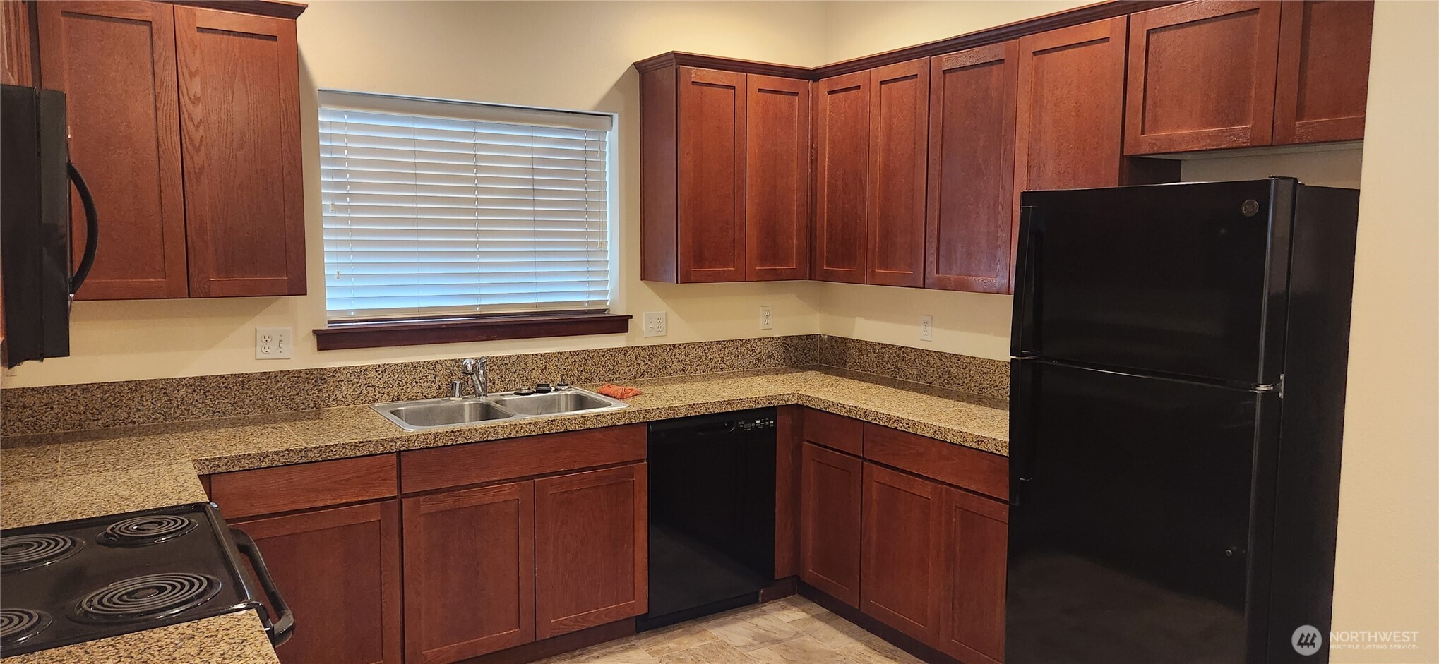 501 North 105th Street, Unit A Seattle, WA 98133 - Photo 3 of 39 a kitchen with a sink and a refrigerator