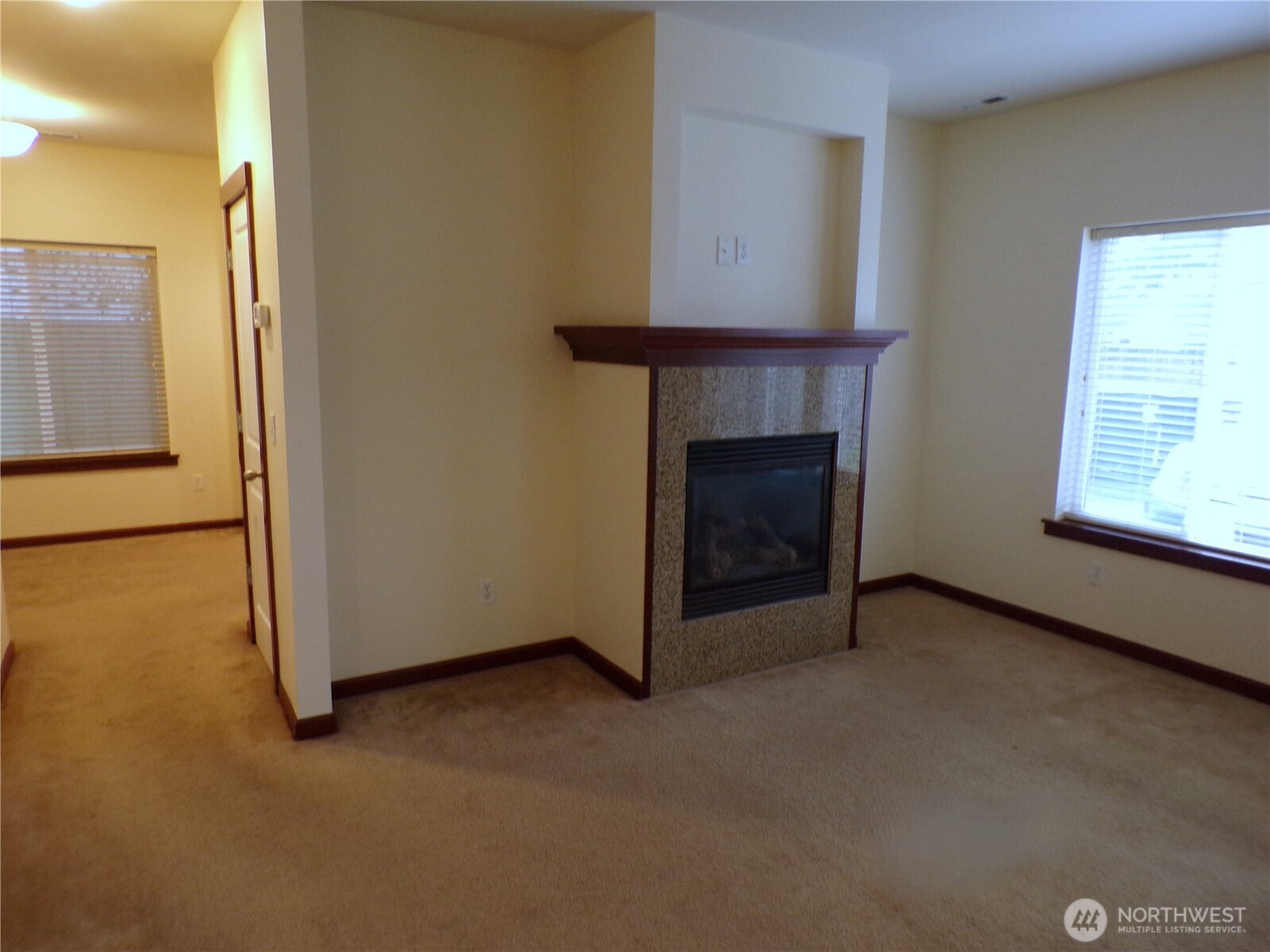 501 North 105th Street, Unit A Seattle, WA 98133 - Photo 8 of 39 a view of an empty room with window and fireplace