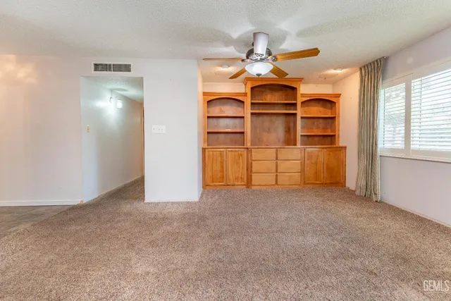 a view of empty room with fireplace