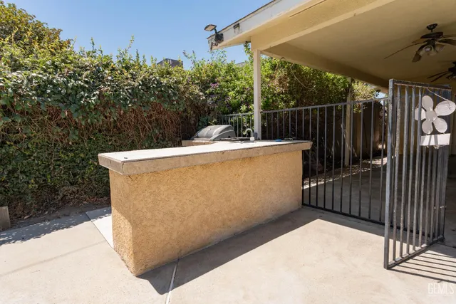a view of a patio with table and chairs and potted plants