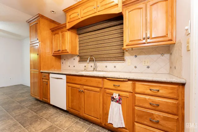 a stove top oven sitting inside of a kitchen