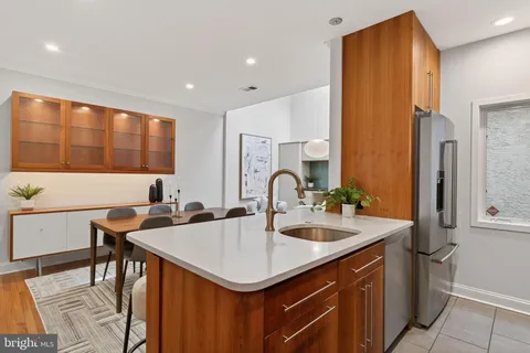 a kitchen with a sink cabinets and window