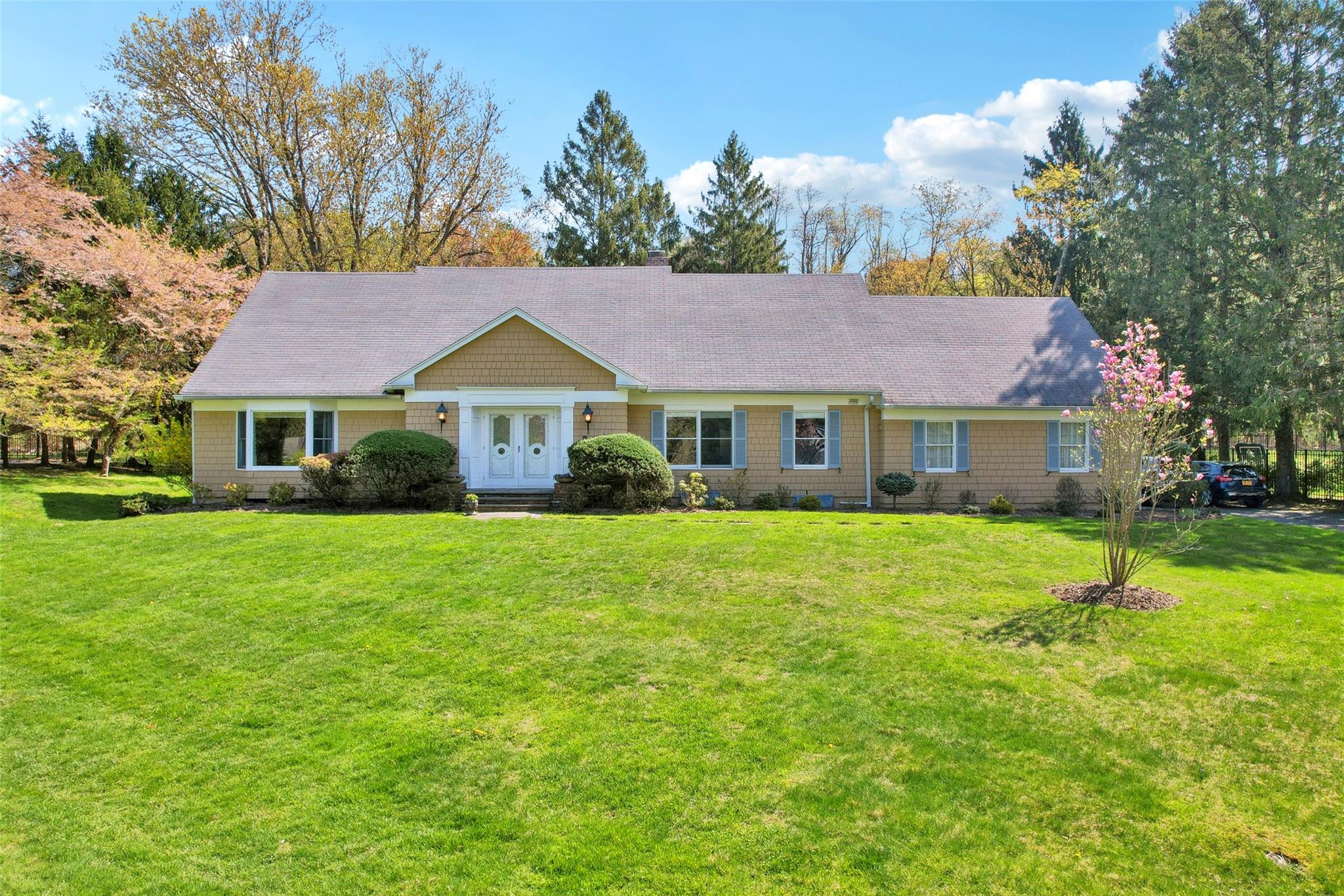 a front view of a house with a garden