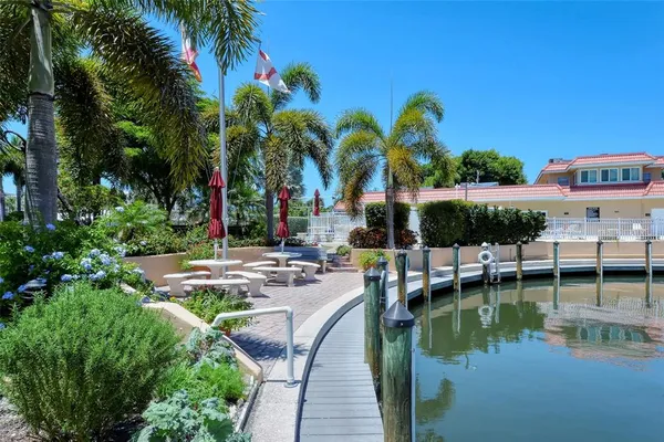 a view of a house with a yard next to a lake