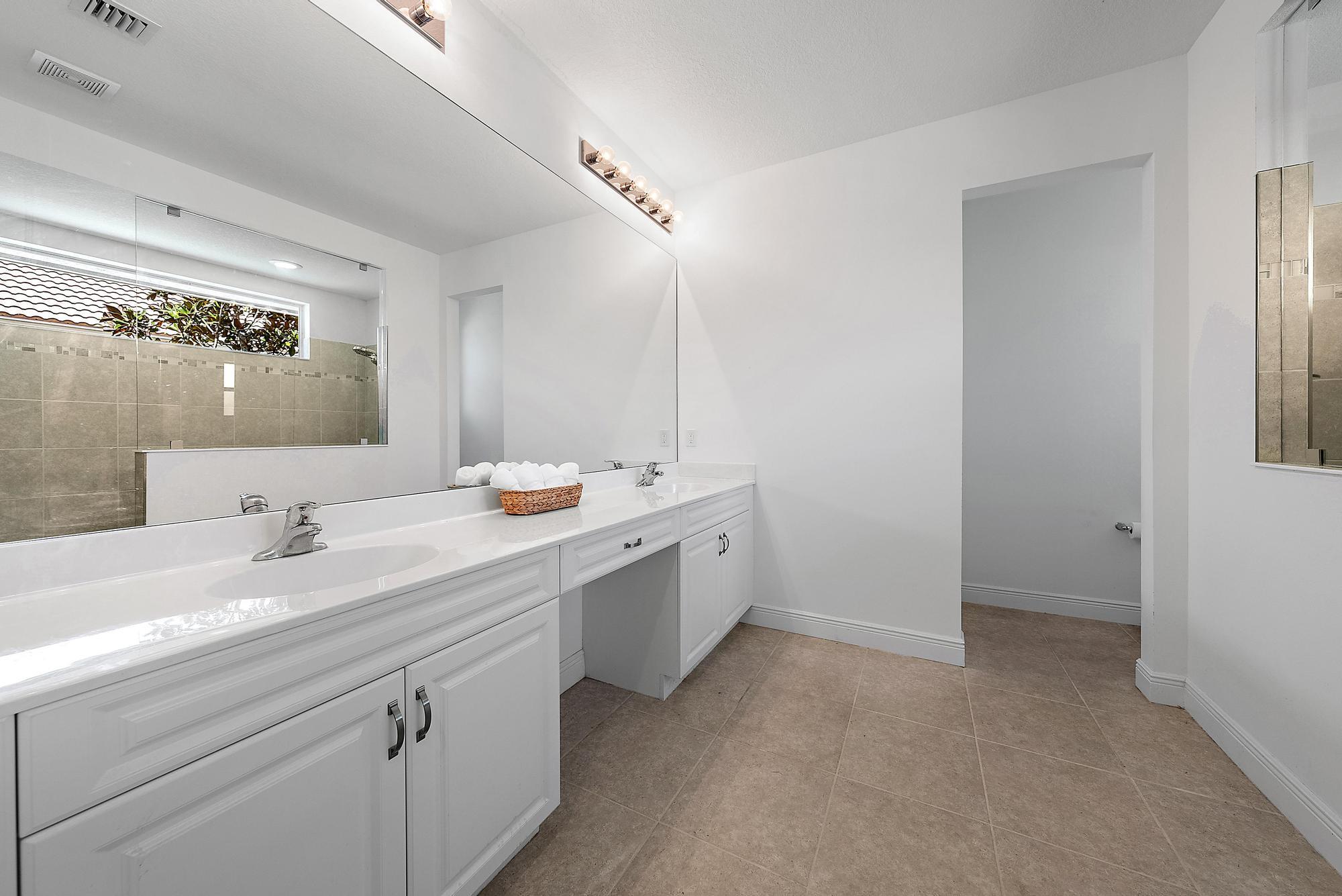 2664 Conifer Drive Fort Pierce, FL 34951 - Photo 15 of 30 a spacious bathroom with double sink and a mirror