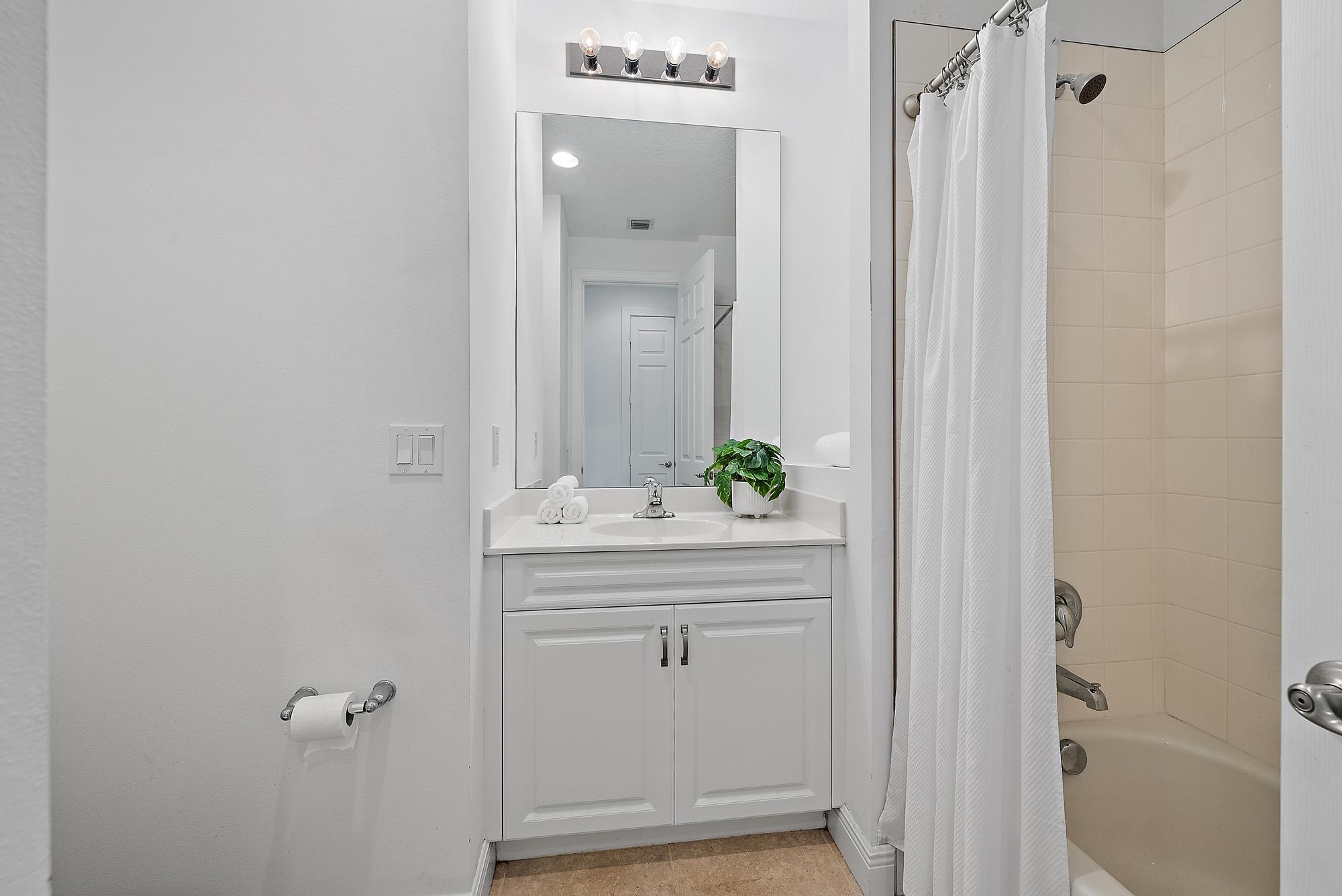 2664 Conifer Drive Fort Pierce, FL 34951 - Photo 16 of 30 a bathroom with a shower and vanity