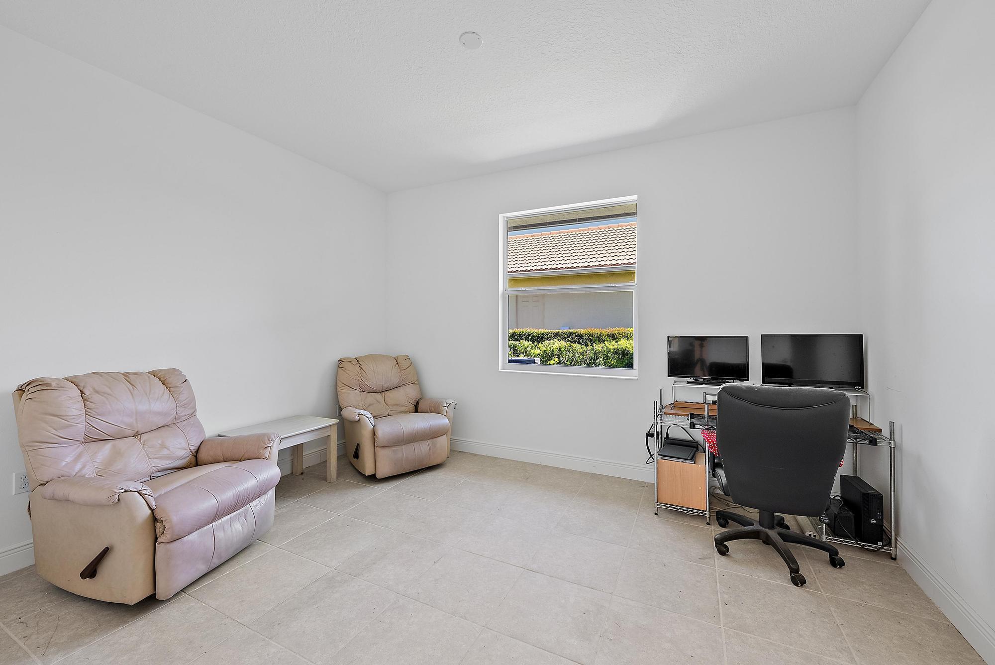2664 Conifer Drive Fort Pierce, FL 34951 - Photo 17 of 30 a livingroom with workspace and a couch