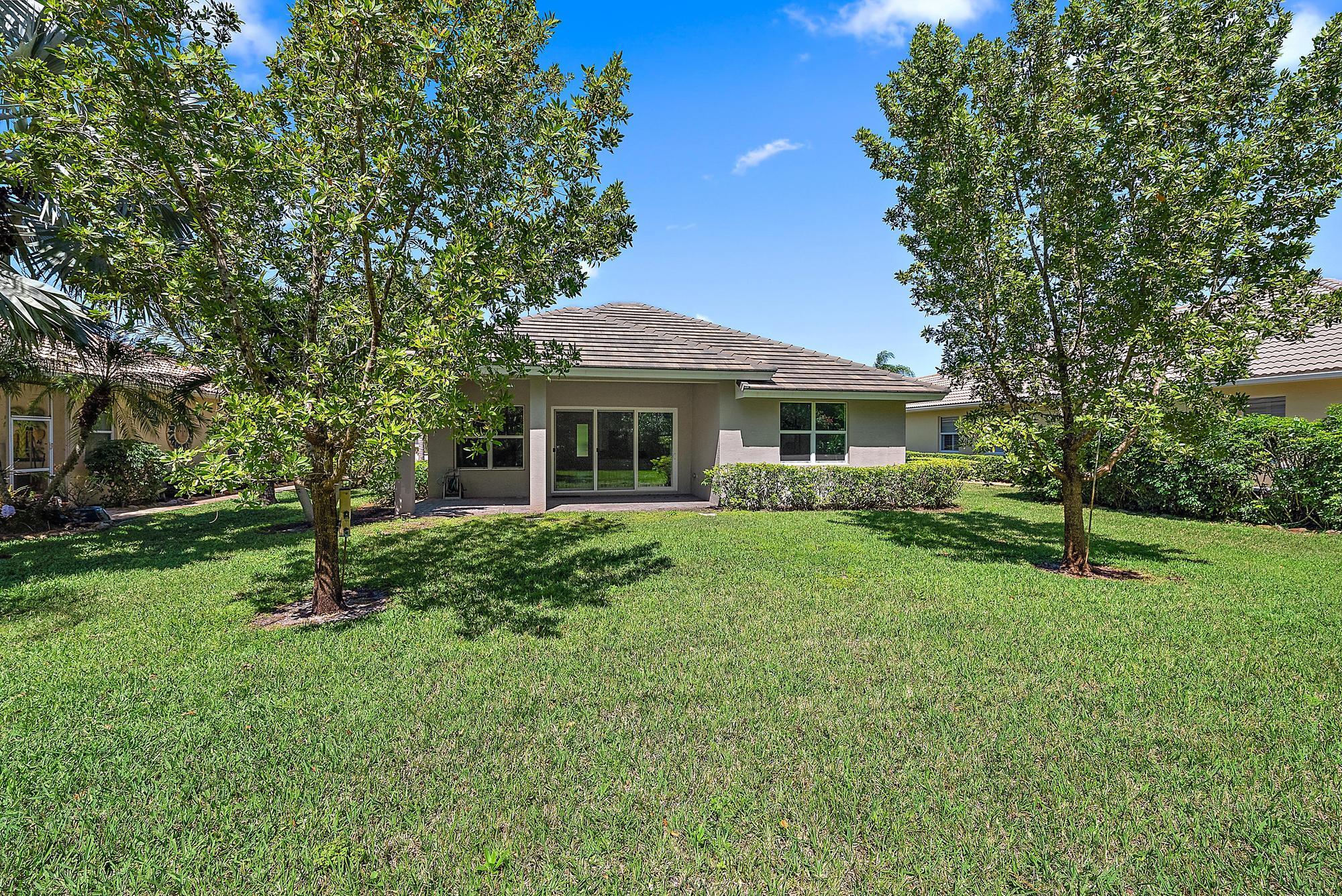 2664 Conifer Drive Fort Pierce, FL 34951 - Photo 29 of 30 a view of an house with backyard space and garden