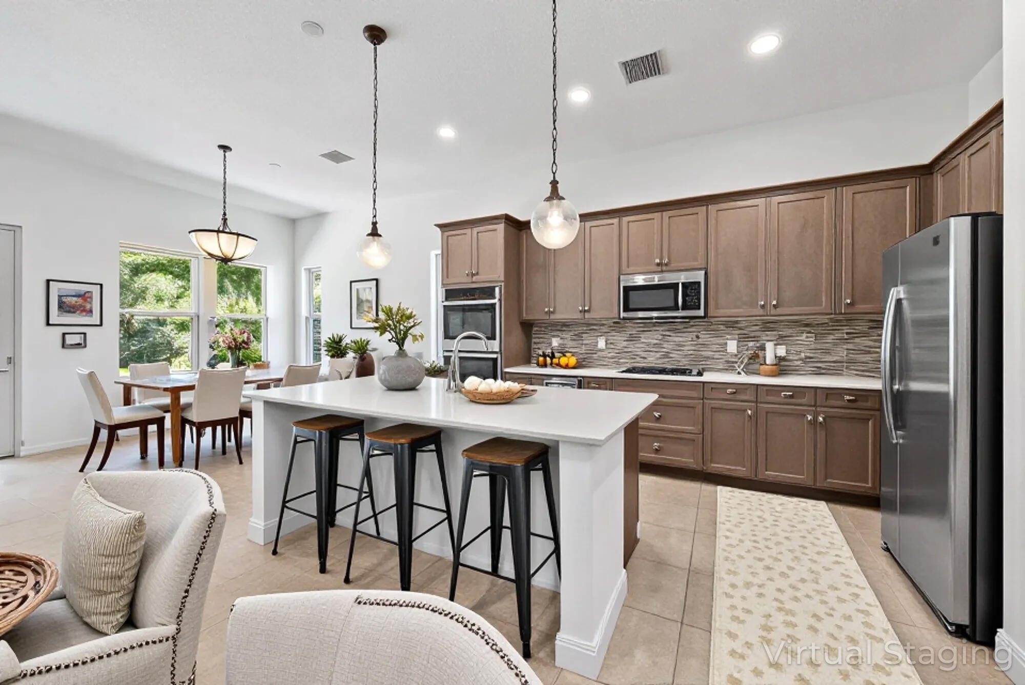2664 Conifer Drive Fort Pierce, FL 34951 - Photo 5 of 30 a kitchen with stainless steel appliances granite countertop a stove a sink a kitchen island with a dining table and chairs
