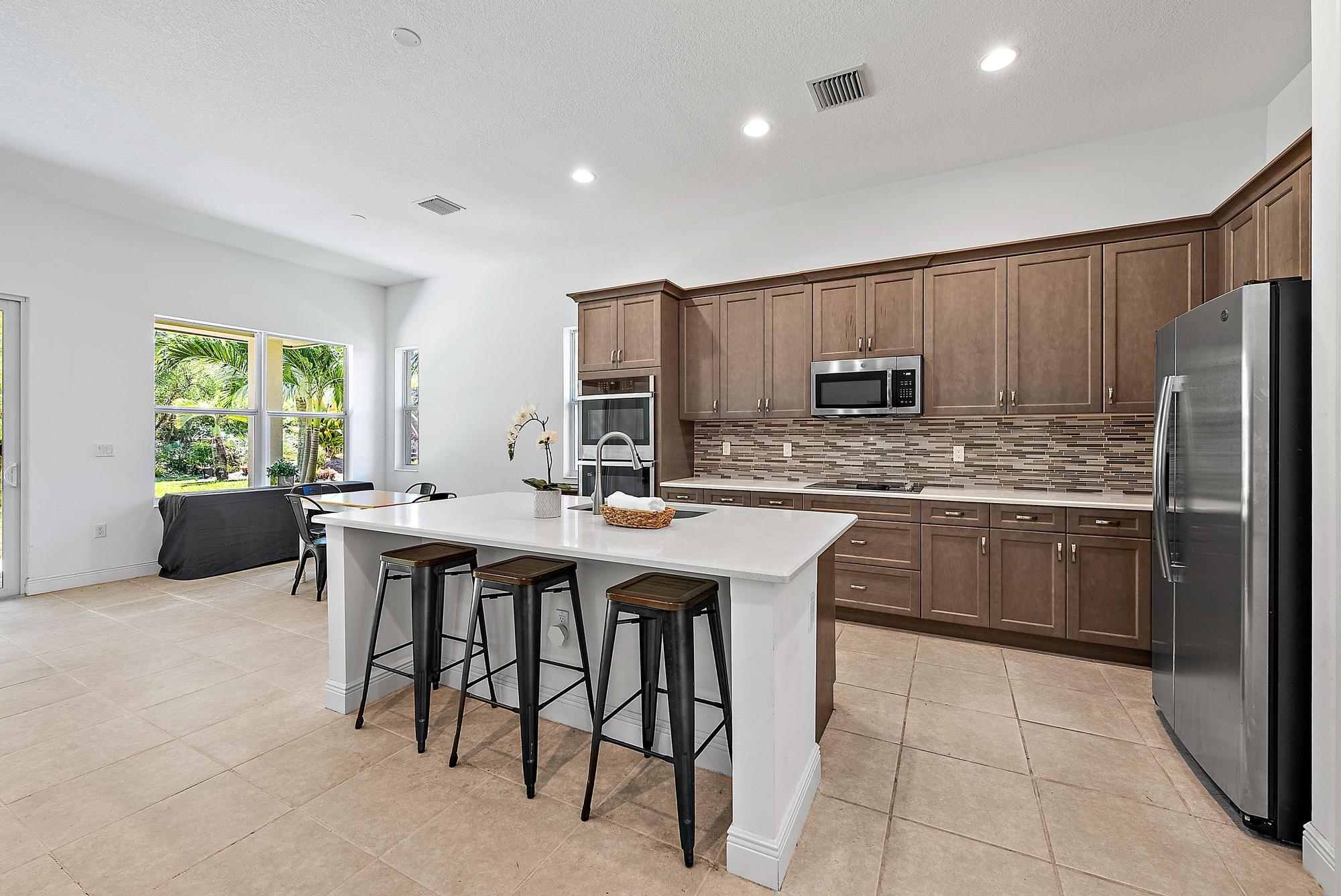 2664 Conifer Drive Fort Pierce, FL 34951 - Photo 6 of 30 a kitchen with stainless steel appliances a sink a counter top space and appliances