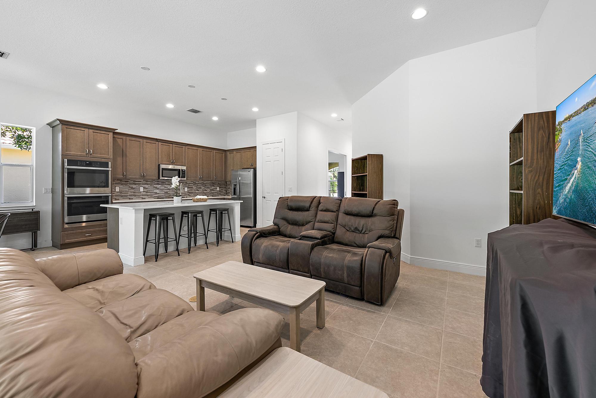 2664 Conifer Drive Fort Pierce, FL 34951 - Photo 9 of 30 a living room with furniture and kitchen view