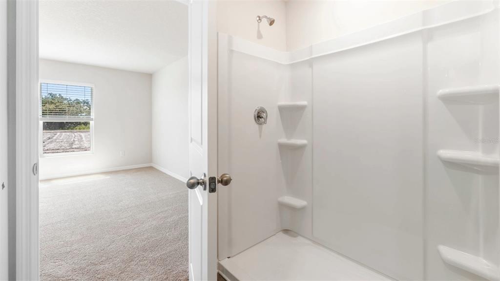 1922 Hammock Trace Drive Parrish, FL 34219 - Photo 13 of 18 a bathroom with a toilet and a shower