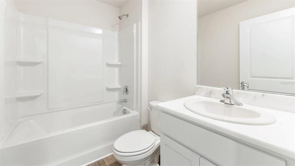 1922 Hammock Trace Drive Parrish, FL 34219 - Photo 15 of 18 a bathroom with a sink toilet and a bathtub