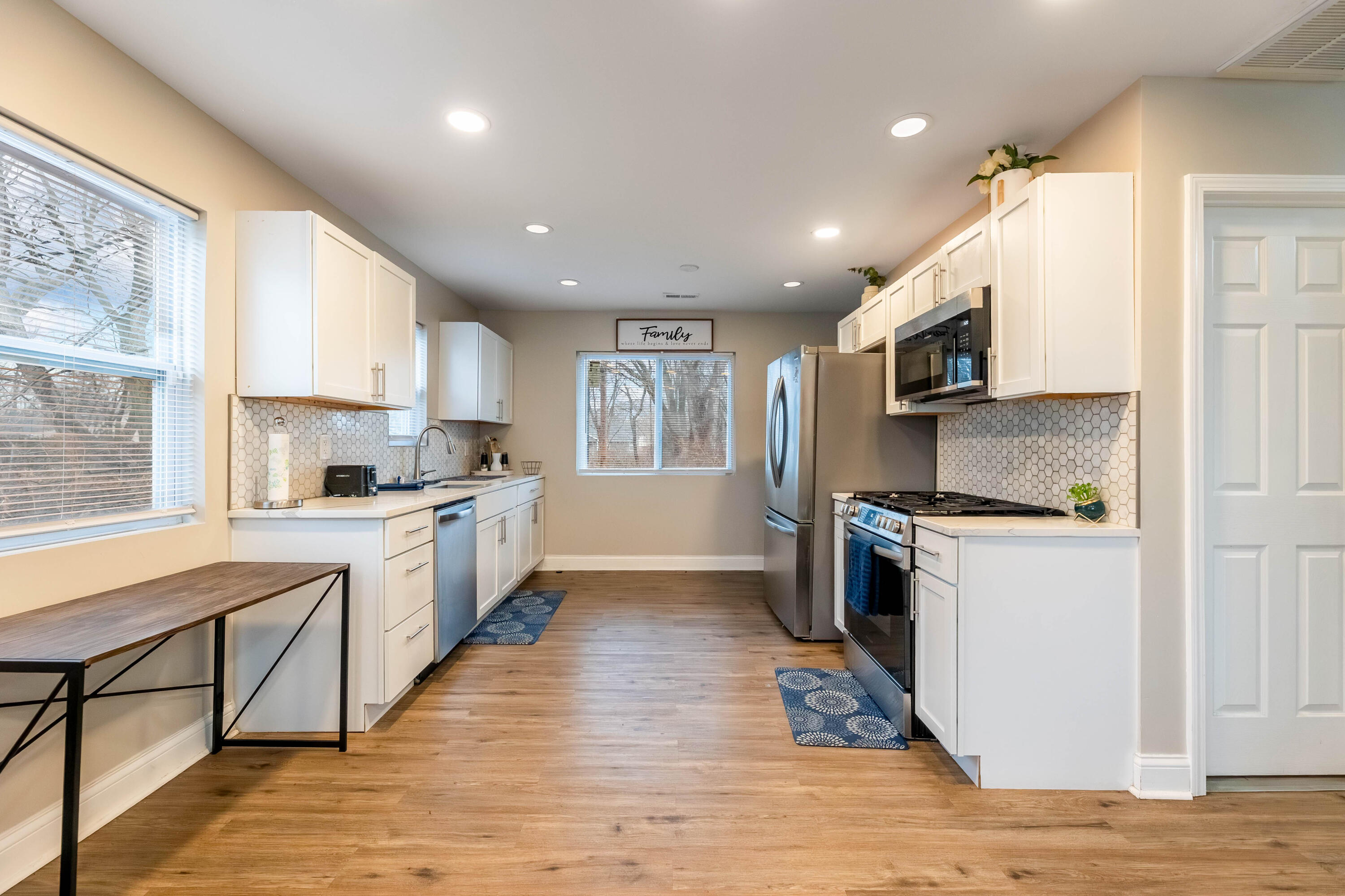 1151 Benton Street Gary, IN 46403 - Photo 6 of 23 a kitchen with stainless steel appliances granite countertop a refrigerator a sink dishwasher a oven with white cabinets and wooden floor