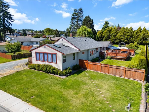 a aerial view of a house with swimming pool and a yard