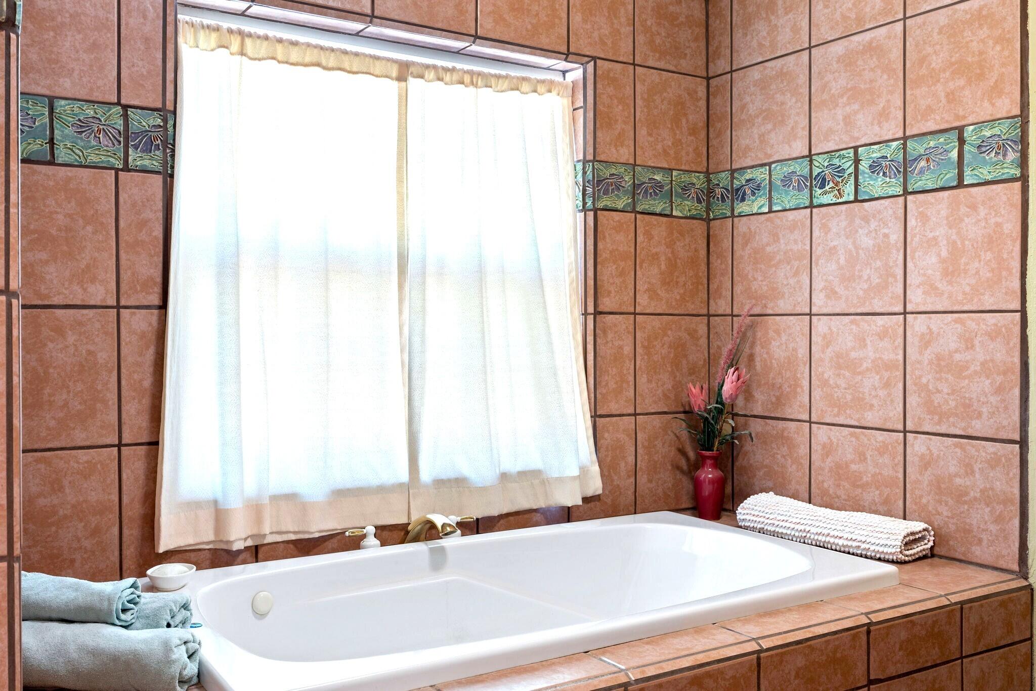 624 Baker Ranch Road Young, AZ 85554 - Photo 17 of 116 a bathroom with a bathtub and next to a window
