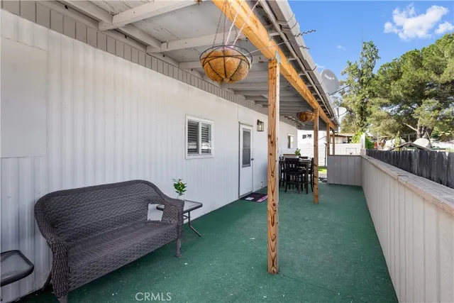 a view of a house with a yard and potted plants