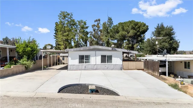 an aerial view of residential house with outdoor space and mountain view in back