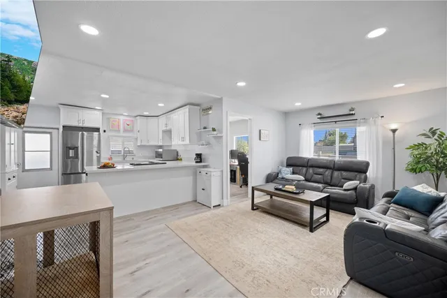 a living room with furniture and kitchen view
