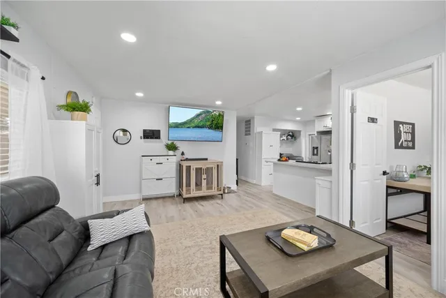 a living room with furniture and kitchen view