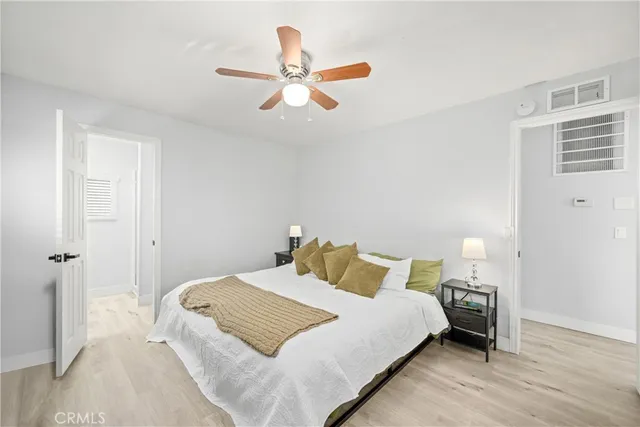 a bedroom with a bed and a ceiling fan