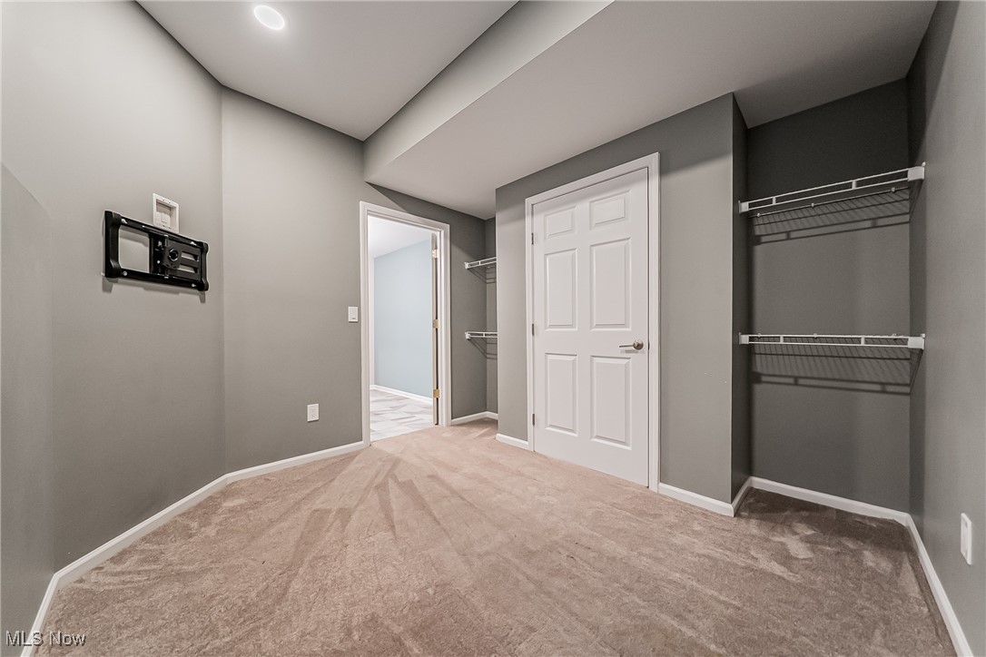 5270 Brainard Road Solon, OH 44139 - Photo 32 of 45 Bonus room in walk out basement off bathroom that can serve as a workout room, play area, office, or for guests with carpet floors, window, storage and wall mount for TV