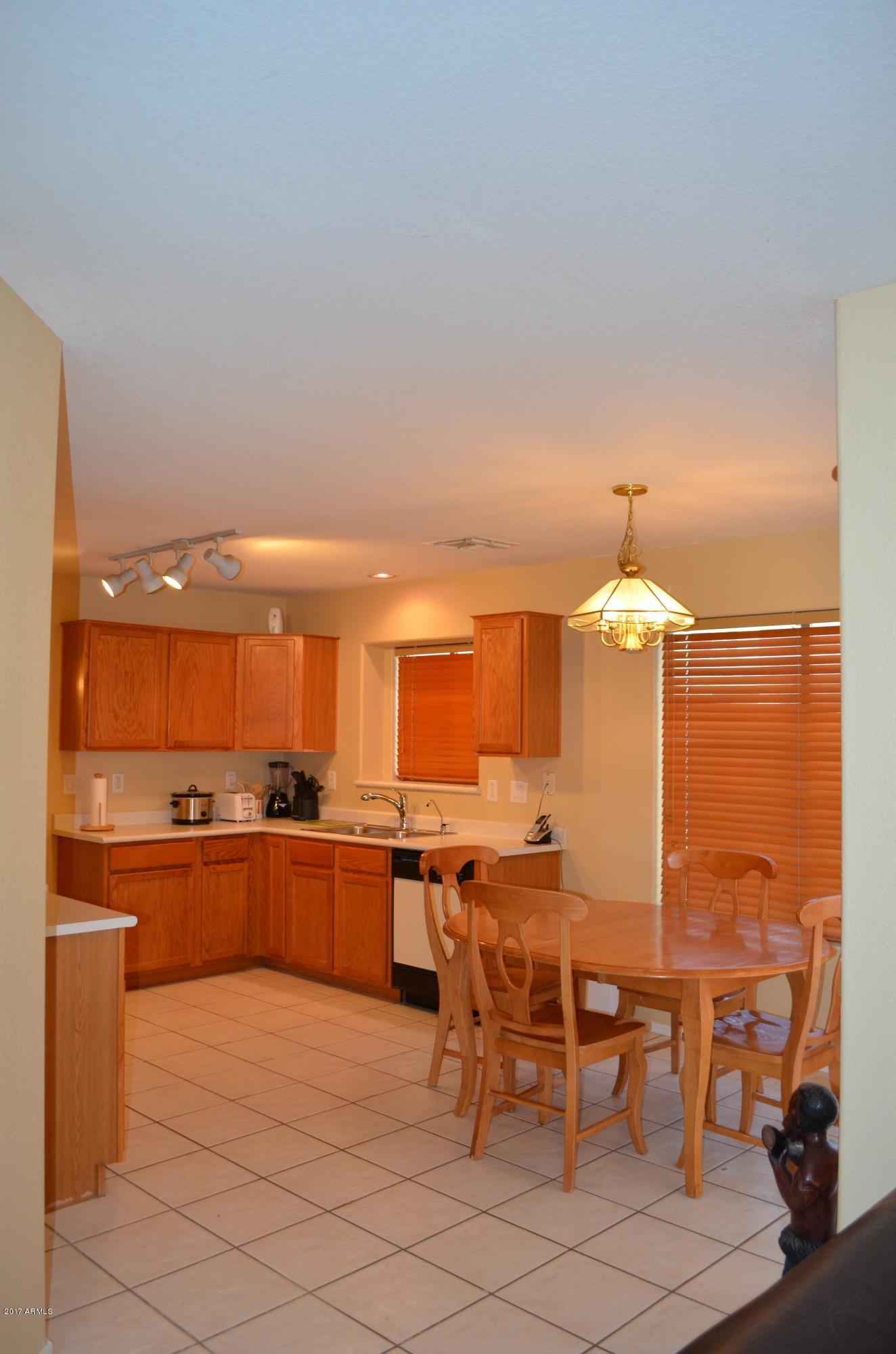 1742 East Del Rio Street Gilbert, AZ 85295 - Photo 4 of 28 a kitchen with a table and chairs in it