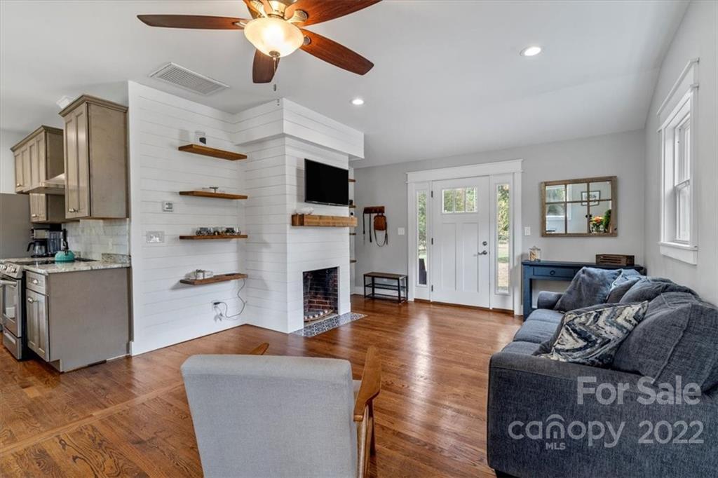 1631 Lawrence Road Clover, SC 29710 - Photo 11 of 48 a living room with furniture a fireplace and a flat screen tv
