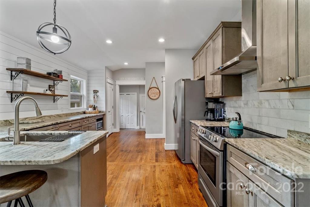 1631 Lawrence Road Clover, SC 29710 - Photo 16 of 48 a kitchen with stainless steel appliances granite countertop a sink stove and refrigerator