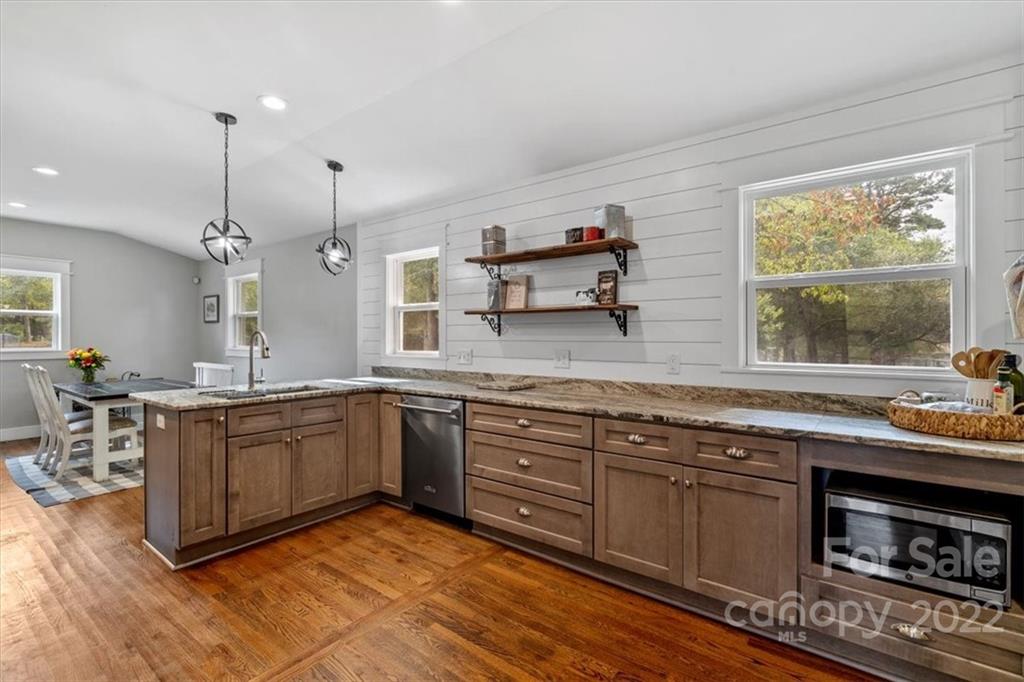 1631 Lawrence Road Clover, SC 29710 - Photo 17 of 48 a kitchen with stainless steel appliances granite countertop a sink a stove and a wooden floors