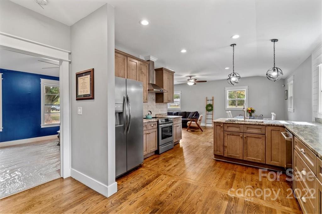 1631 Lawrence Road Clover, SC 29710 - Photo 18 of 48 a kitchen with stainless steel appliances granite countertop a refrigerator a oven a sink and a wooden floors