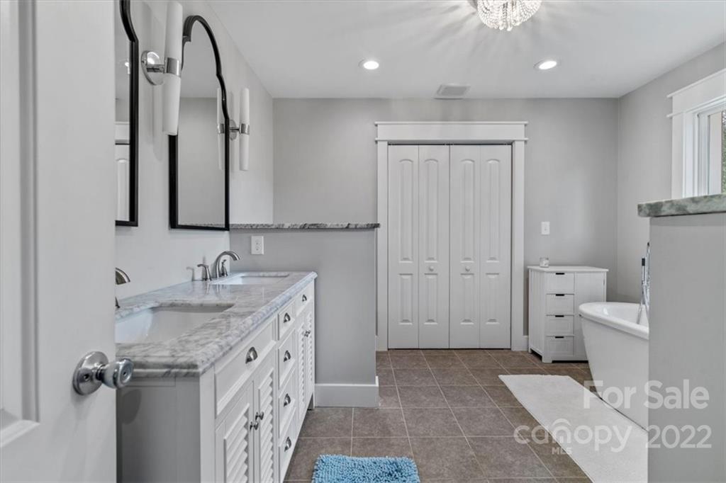 1631 Lawrence Road Clover, SC 29710 - Photo 25 of 48 a spacious bathroom with a double vanity sink a mirror and a bathtub