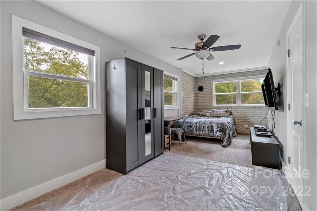 1631 Lawrence Road Clover, SC 29710 - Photo 33 of 48 a bedroom with a bed large window and flat screen tv