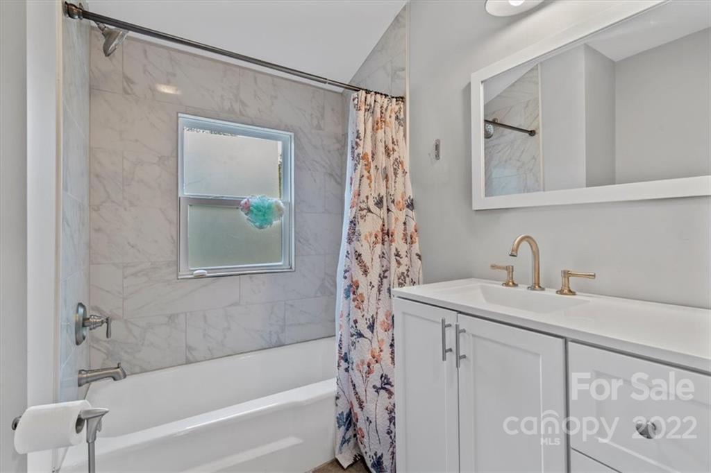 1631 Lawrence Road Clover, SC 29710 - Photo 36 of 48 a bathroom with a bathtub a sink and a window