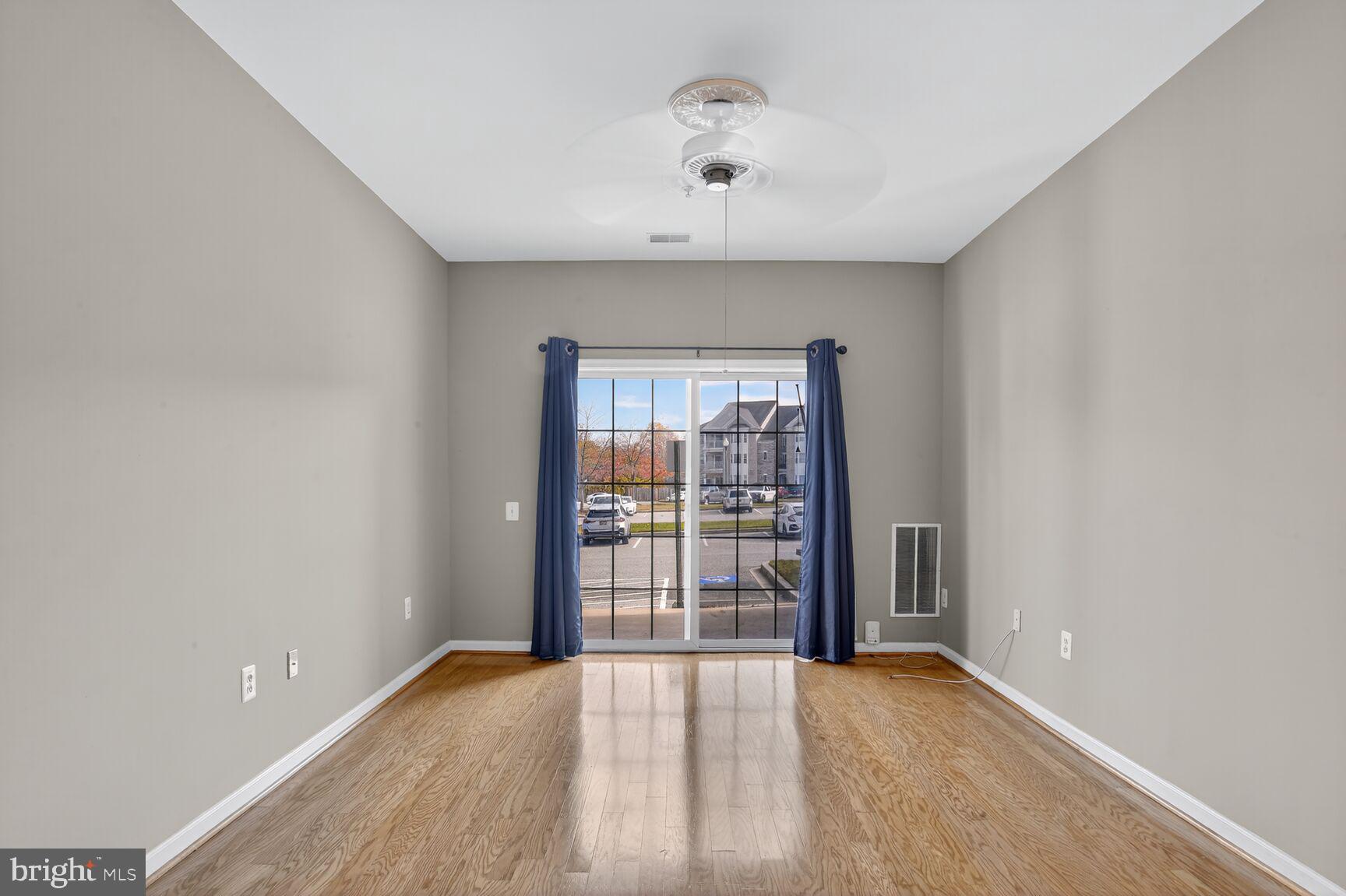 402 Aggies Circle, Unit 402D Bel Air, MD 21014 - Photo 18 of 29 wooden floor in an empty room with a window