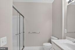 402 Aggies Circle, Unit 402D Bel Air, MD 21014 - Photo 4 of 29 a bathroom with a granite countertop toilet a sink and a mirror