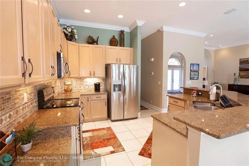 12253 Rockledge Circle Boca Raton, FL 33428 - Photo 11 of 22 a kitchen with a refrigerator a sink and a stove