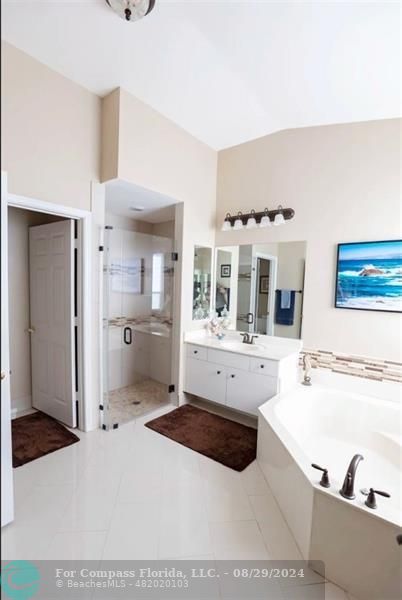 12253 Rockledge Circle Boca Raton, FL 33428 - Photo 13 of 22 a large bathroom with a tub sink and mirror
