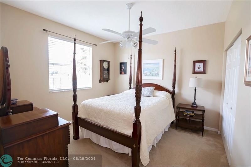 12253 Rockledge Circle Boca Raton, FL 33428 - Photo 15 of 22 a bedroom with a bed and a window